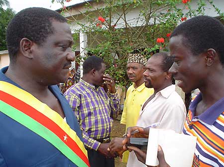 The Mayor of Tinto, at left, wearing Cameroonian flag sash.